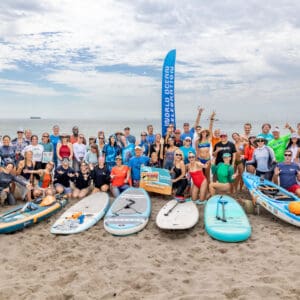 Group with surfboards on beach at World Ocean Celebration 2026